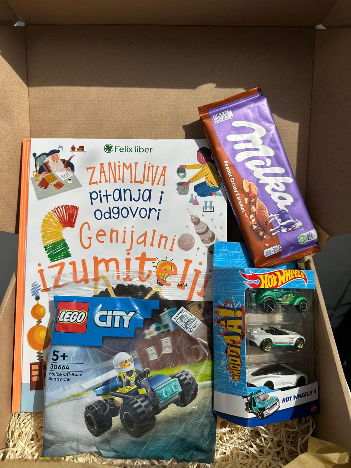 Young Explorer gift box with educational games, fun treats, and creative accessories.