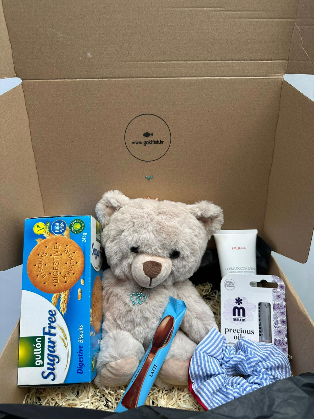 Soft teddy plush toy in a charming gift box, perfect for cuddling and gifting.