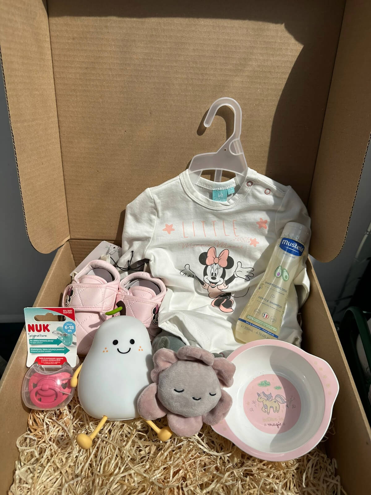 Baby Minnie gift box with pacifier and cute baby essentials for newborn care.