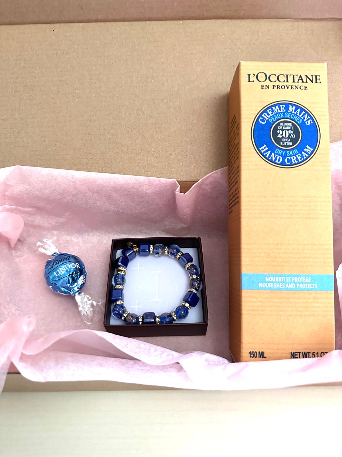 Blue bracelet and nourishing hand cream set for daily care and stylish accessorizing.