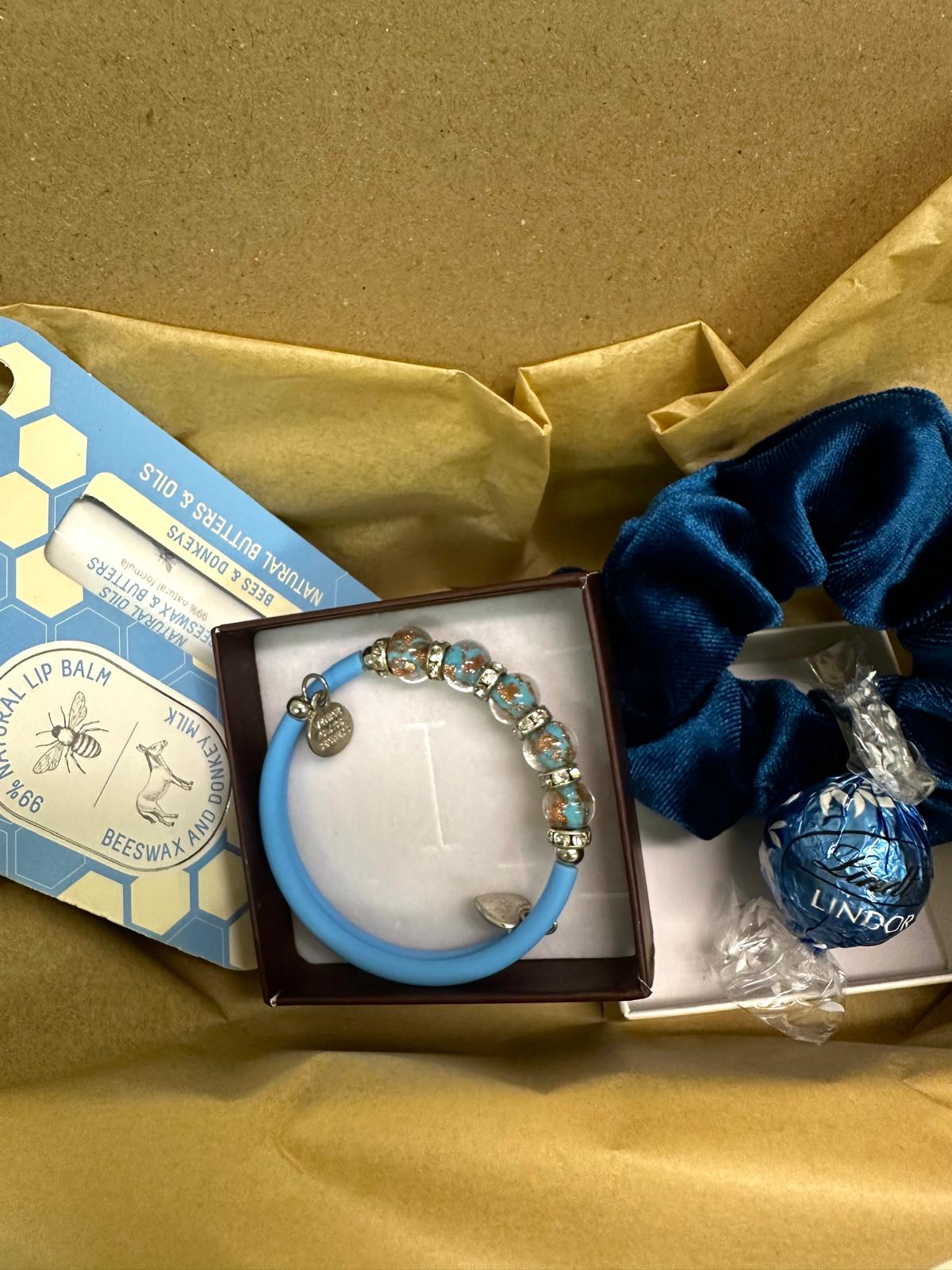 Lip balm and stylish blue bracelet set, perfect for daily care and fashion.