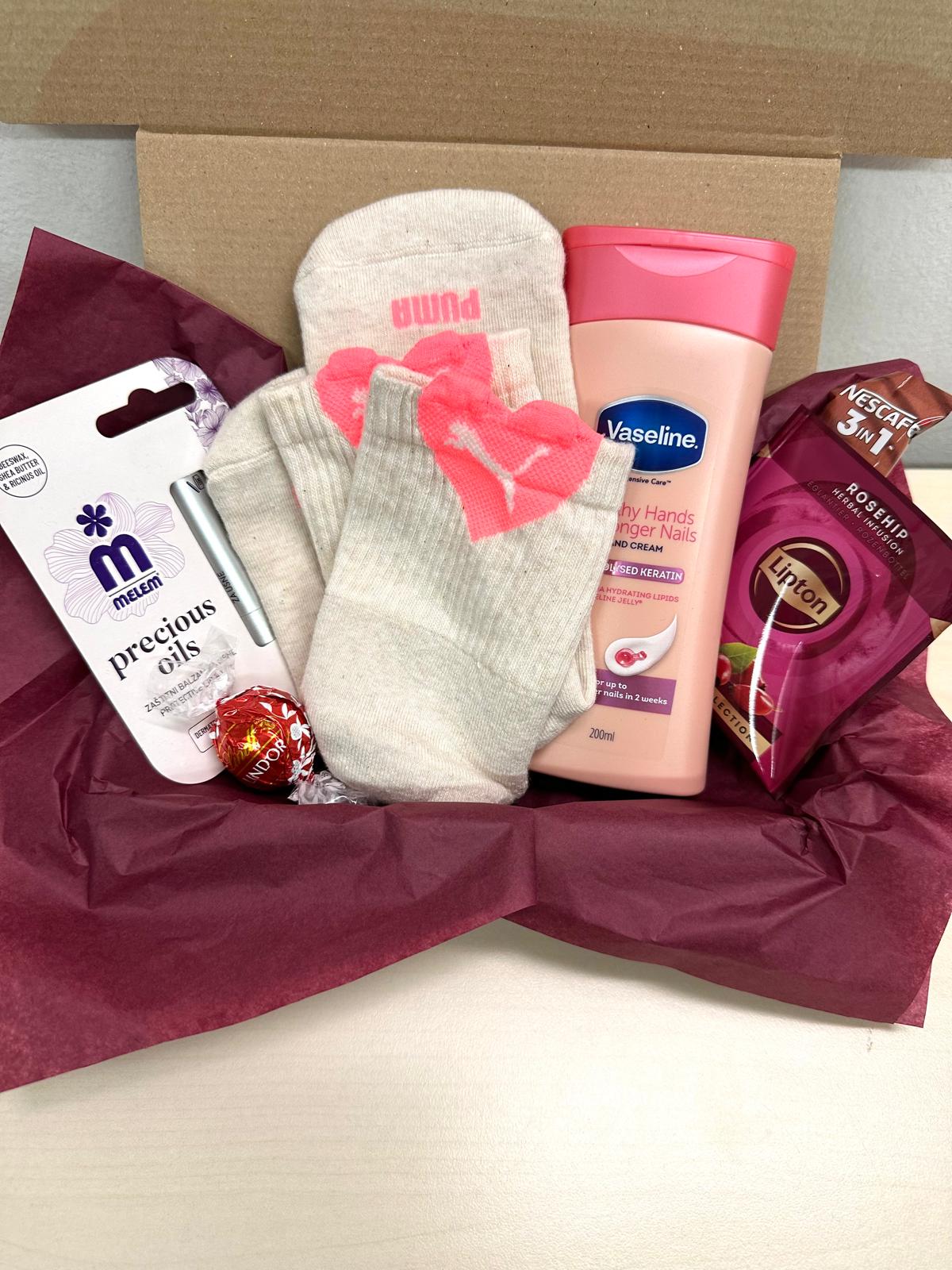 Pink Care gift box with skincare products and pampering essentials for daily self-care.